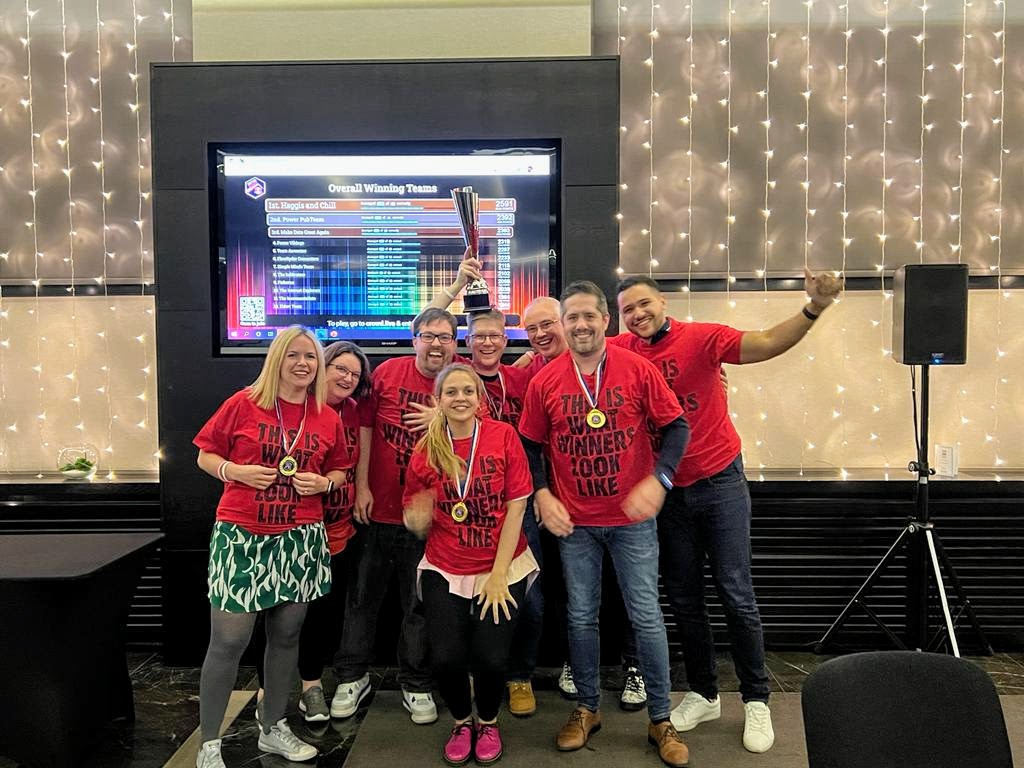 Group shot of the Haggis and Chips team with the trophy for winning the charity pub quiz at Scottish Summit